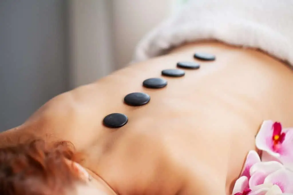 Hot stones on a person's back