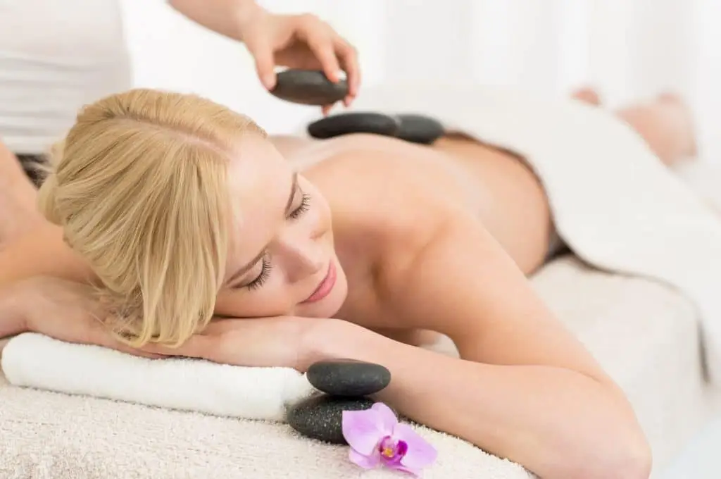 Woman receiving a hot stone massage.